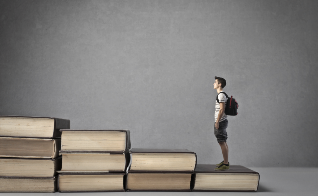 man go up from book stairs